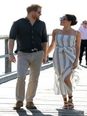 Prince Harry and Duchess Meghan shake hands while strolling along the Kingfisher Bay Pier during a visit to Fraser Island, Australia on October 22, 2018.