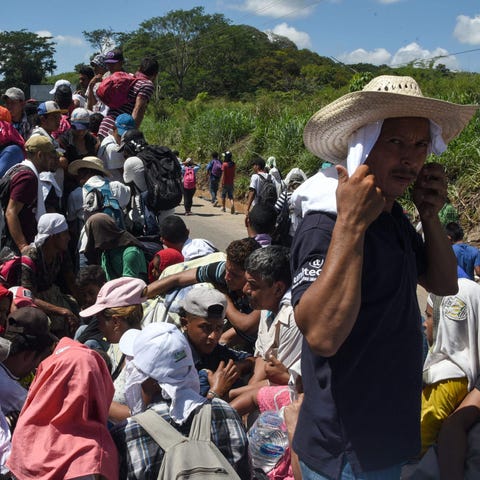 Honduran migrants take part in a caravan heading...