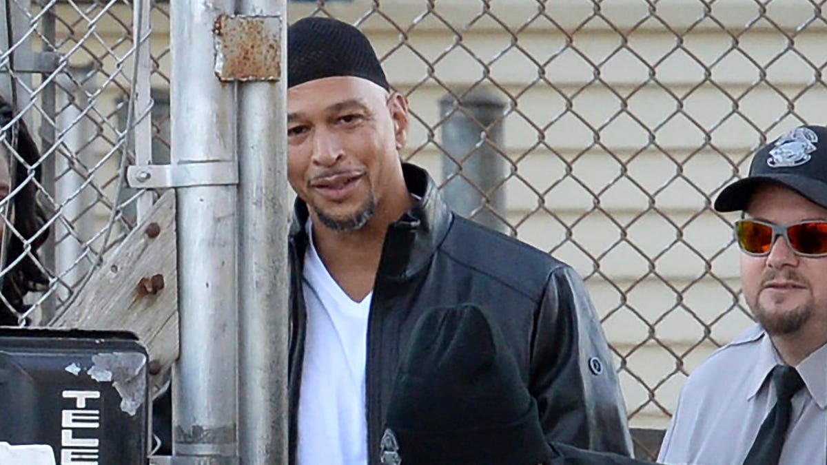Former Carolina Panthers NFL football player Rae Carruth, center rear, exits the Sampson Correctional Institution in Clinton, N.C., on Oct. 22,. Carruth has been released from prison after serving nearly 19 years for conspiring to murder the mother of his unborn child.