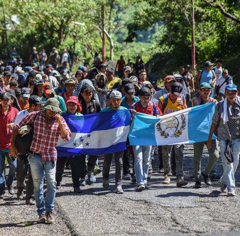 Migrants take part in a new caravan, Monday,...