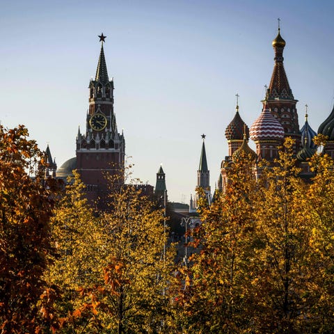 The Kremlin hides behind autumn leaves in Moscow,...