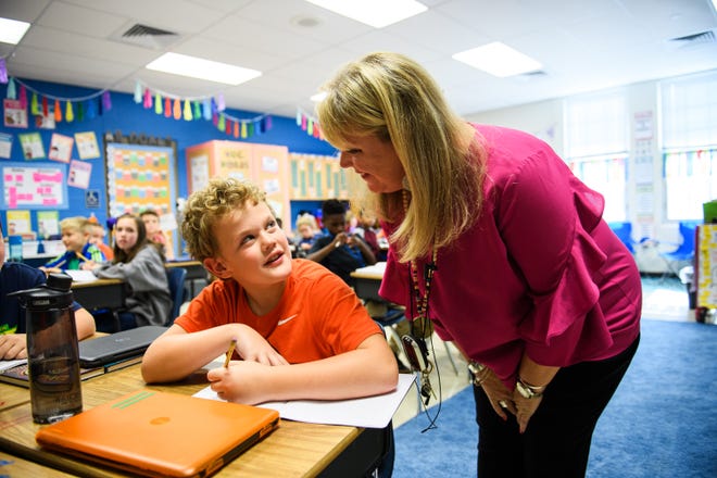 Fourth grade teacher Beth Hadley works with her student, Walker Key, 9, at Rudolph G. Gordon School on Tuesday, Oct. 23, 2018. Key and Hadley both went to a Clemson vs. N.C. State football game at Memorial Stadium, where Hadley was helped onto the field by N.C. State offensive lineman Terronne Prescod after the game.