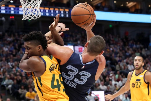 Oct 22, 2018; Salt Lake City, UT, USA; Utah Jazz guard Donovan Mitchell (45) fouls Memphis Grizzlies center Marc Gasol (33) before Gasol can attempt a shot during the first quarter at Vivint Smart Home Arena.