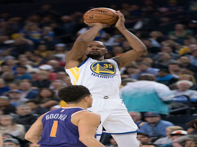 October 22, 2018; Oakland, CA, USA; Golden State Warriors forward Kevin Durant (35) shoots the basketball against Phoenix Suns guard Devin Booker (1) during the third quarter at Oracle Arena. Mandatory Credit: Kyle Terada-USA TODAY Sports