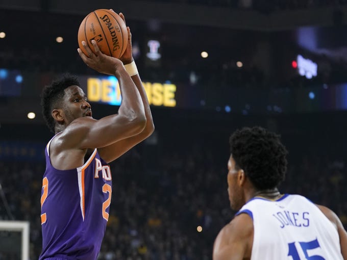 October 22, 2018; Oakland, CA, USA; Phoenix Suns center Deandre Ayton (22) shoots the basketball against Golden State Warriors center Damian Jones (15) during the first quarter at Oracle Arena. Mandatory Credit: Kyle Terada-USA TODAY Sports