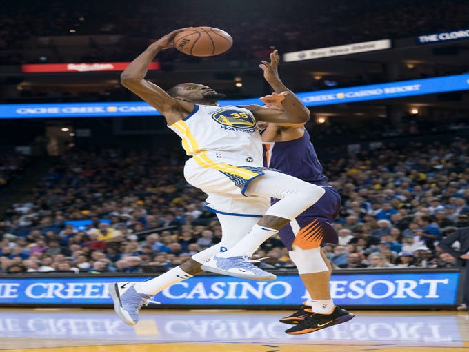 October 22, 2018; Oakland, CA, USA; Golden State Warriors forward Kevin Durant (35) is fouled by Phoenix Suns guard Devin Booker (1) during the third quarter at Oracle Arena. Mandatory Credit: Kyle Terada-USA TODAY Sports