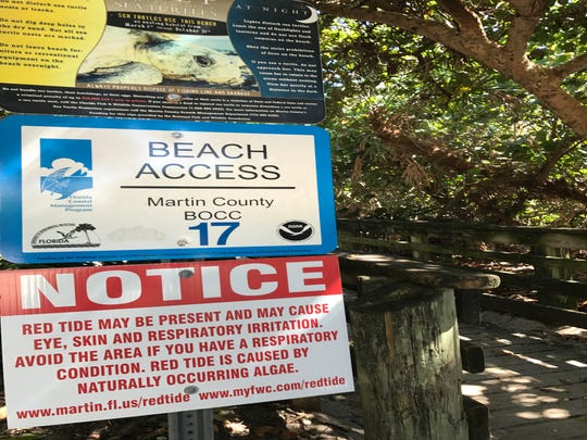 A sign at the entrance to Virginia Forrest Beach, in Martin County, warns visitors of the possible red tide.