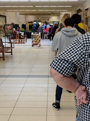 A steady stream of lunchtime voters wait as long as 25 minutes in line at Sikes Senter Mall in Wichita Falls to cast their ballots for early voting. Monday's turnout approaches 2016 presidential election figure.