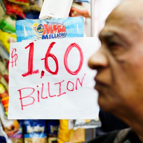 A man buys a ticket for the Mega Millions lottery...