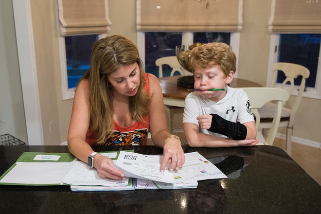 Mindie Barnett works on homework with her son Julian Lichterman, 7, earlier this fall in their Voorhees home.