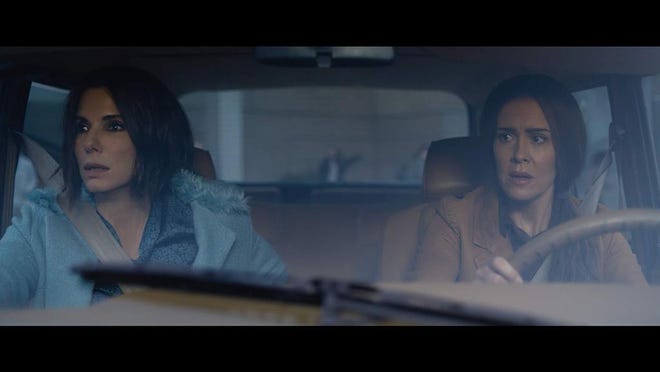 Sandra Bullock, left, and Sarah Paulson star in the post-apocalyptic “Bird Box.”