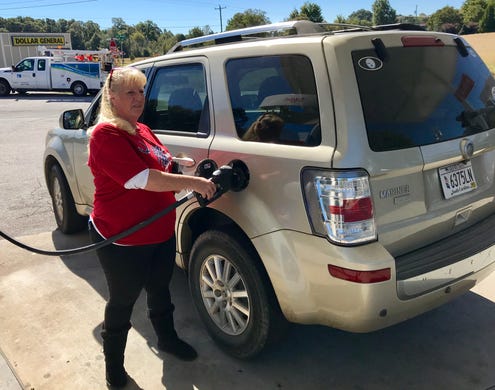 Cynthia Eldridge talks with employees at KC Mart on Wednesday, Oct. 24, 2018, trying to figure out who had bought the winning Mega Millions jackpot ticket.