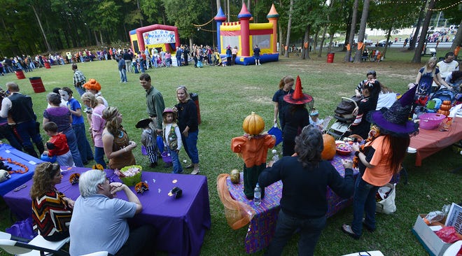 Trick or treaters make their way past tables receiving candy at the city of Wetumpka Candy Walk