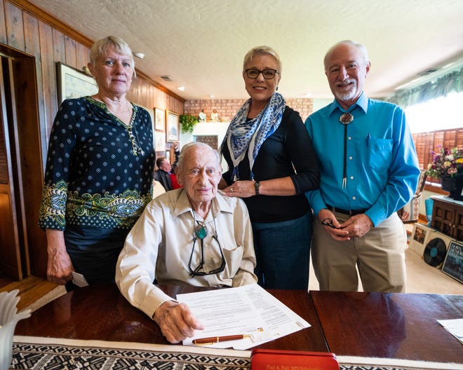 Seated is Paul A. Feil, M.D., at the signing of a Western New Mexico University Foundation scholarship in his name. Also pictured, from left, are Dr. Feil’s children: Anita Feil, Nancy Feil Pool and Paul Feil. (Dr. Feil’s son David is not pictured.)