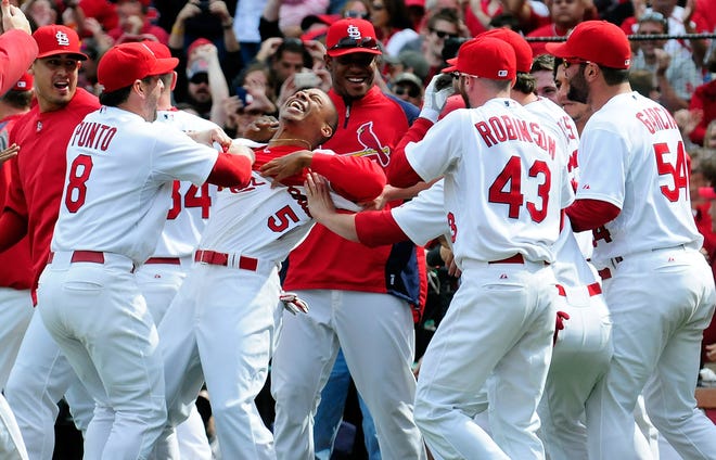 ST. LOUIS, MO - SEPTEMBER 24: Adron Chambers #56 of the St. Louis Cardinals celebrates with his teammates after scoring on a wild pitch by Carlos Marmol #49 of the Chicago Cubs at Busch Stadium on September 24, 2011 in St. Louis, Missouri.  (Photo by Jeff Curry/Getty Images)