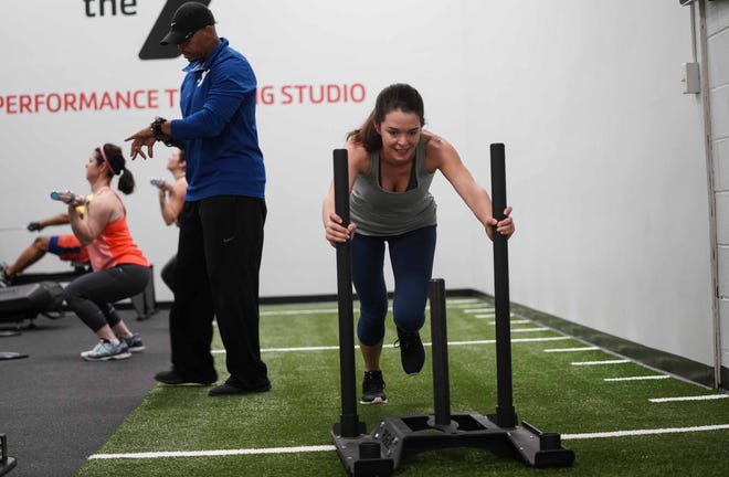 Nicole Freedman, a member at the Central YMCA, pushes a sled during a class at new Performance Training Studio that gives members a quick 30-45 minute interval training session with new innovative equipment.