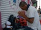 Marvin Sanabria, a Central American migrant traveling with a caravan to the U.S., kneels in prayer after waking up, in Huixtla, Mexico, Tuesday. The caravan, estimated to include more than 7,000 people, had advanced but still faced more than 1,000 miles, and likely much further, to the end of the journey.
