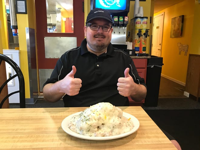 Fidler's on the Grand co-owner and chef Devin Fidler with an order of the Jamestown Loaded. The Jamestown Loaded is 4 grilled buttermilk biscuits, hand-cut red potatoes, 2 over-easy eggs, topped with homemade sausage gravy and cheddar cheese.