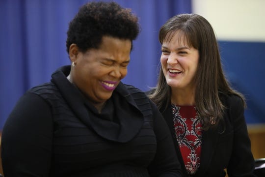 Erica Stephens laughs with Tennessee Education Commissioner Candice McQueen as Stephens is announced as the winner of the Milken Educator Award during an assembly at John P. Freeman Optional School.