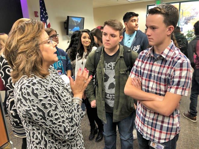 Gov. Susanna Martinez, left, speaks to San Juan College High School students Gus Guikema, middle, and Kaden Fuller, right, after a presentation recognizing the school on Thursday at San Juan College.