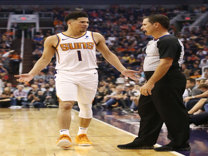 Phoenix Suns' Devin Booker receives a technical foul by offical David Guthre against the Los Angeles Lakers in the first half during a game on Oct. 24 at Talking Stick Resort Arena.