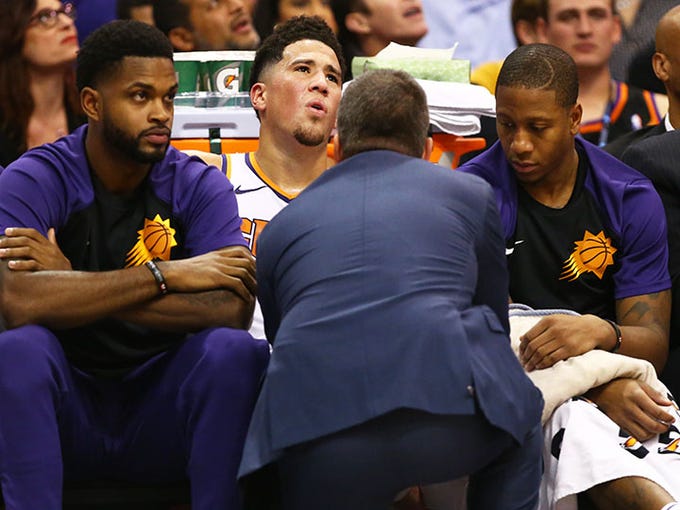 Phoenix Suns' Devin Booker reacts as his leg is examined by a trainer against the Los Angeles Lakers in the second half during a game on Oct. 24 at Talking Stick Resort Arena.