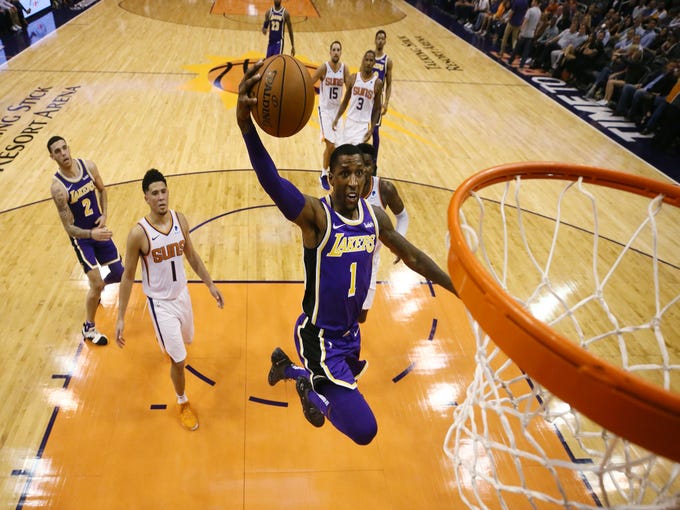 Los Angeles Lakers' Kentavious Caldwell-Pope dunks the ball against the Phoenix Suns during a game on Oct. 24 at Talking Stick Resort Arena.