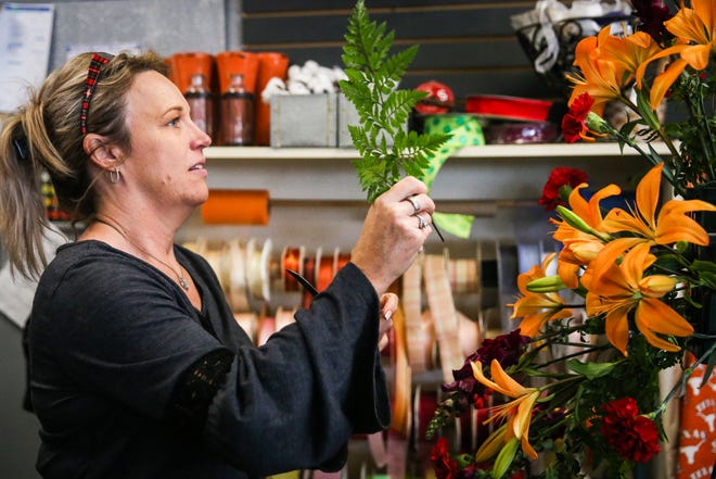 Christi Yancey makes an arrangement Tuesday, Oct. 23, 2018, at Friendly Flower Shop.