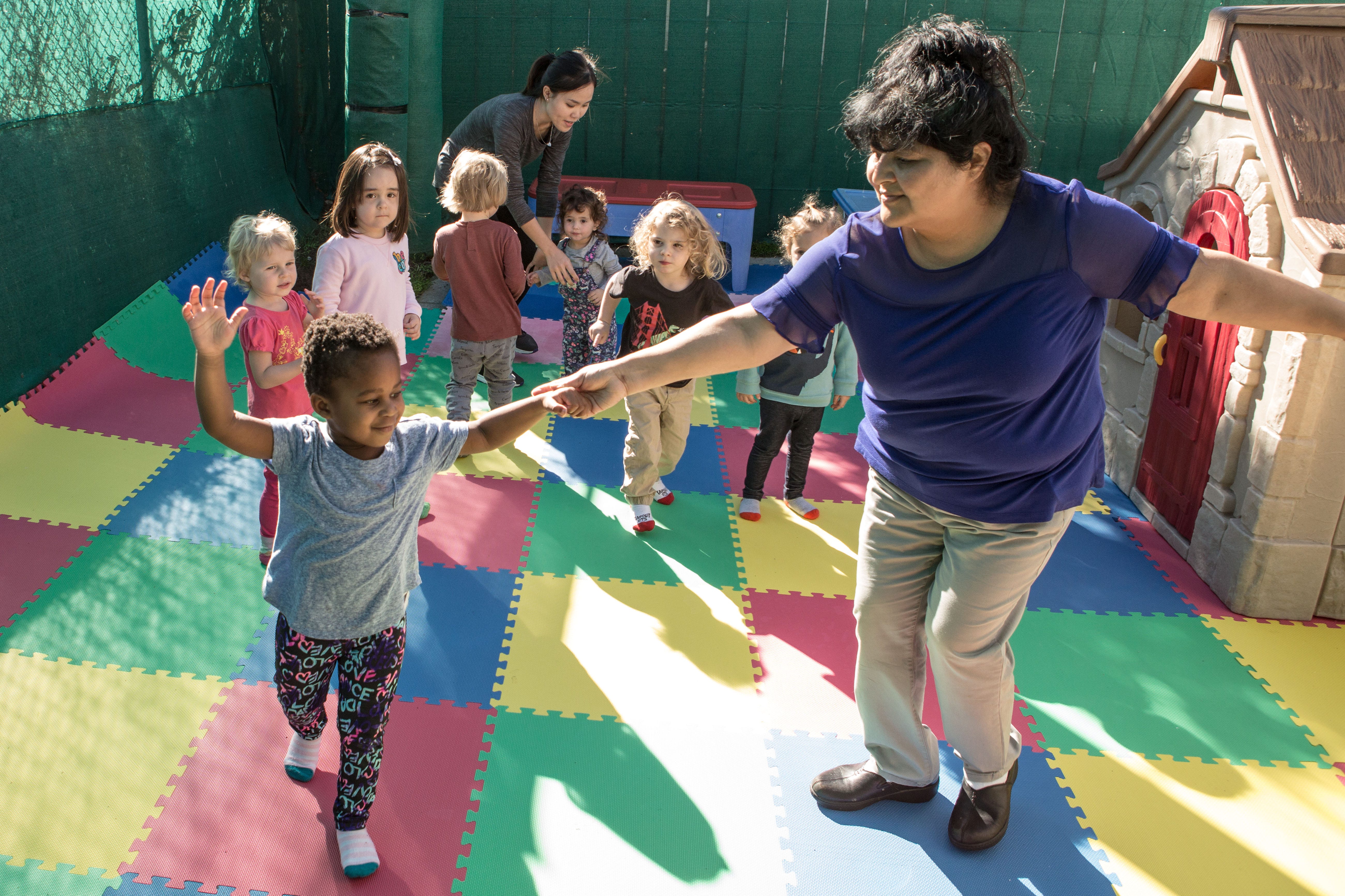 Zonia Torres, child care provider and educator at Shining Stars Family Child Care in San Francisco, dances with preschoolers Oct. 24.