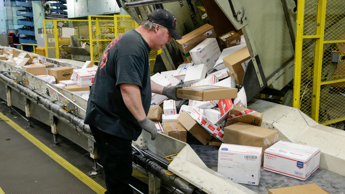 A postal worker arranges packages on a conveyor belt at the main post office in Omaha, Neb. The shipment of several pipe bombs to CNN and several prominent Democrats raises fresh questions about mail safety and what measures the U.S. Postal Service and private delivery services take to prevent explosives and other illegal substances from entering into the mail.