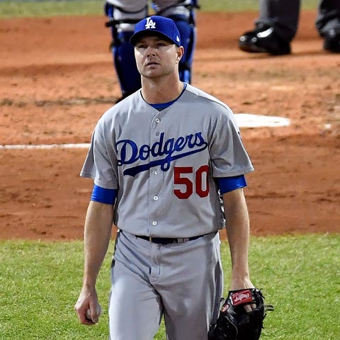 Dodgers relief pitcher Ryan Madson reacts after a...