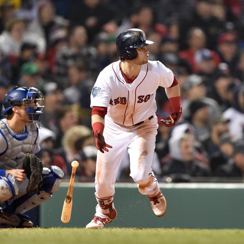 Red Sox outfielder Andrew Benintendi delivers a...