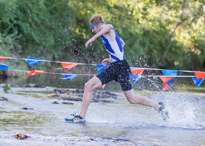Andrew McCallum runs through Sugar Creek at Beaver Crossing at the 2018 Frontier Athletic Conference cross-country race. Andrew would take first place at the race with a time of 16:48.00 even though, this time last year, Andrew could barely run due to having Guillain-Barre syndrome, a rare disorder in which your body’s immune system attacks your nerves.