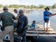 Mexican Federal Police and Immigration officers check identification of the border crossers from Guatemala, who were crossing in a raft at Cuidad Hidalgo, Mexico on Oct. 25, 2018.