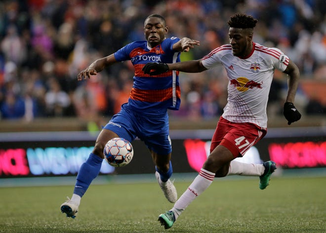 FC Cincinnati forward Fanendo Adi (9) and New York Red Bulls II defender Hassan Ndam (47) race to the ball in the second half of the USL Eastern Conference Semifinal match between the FC Cincinnati and the New York Red Bulls II at Nippert Stadium in Cincinnati on Tuesday, Oct. 16, 2018. FC Cincinnati was eliminated from the playoffs with a 1-0 loss to New York.