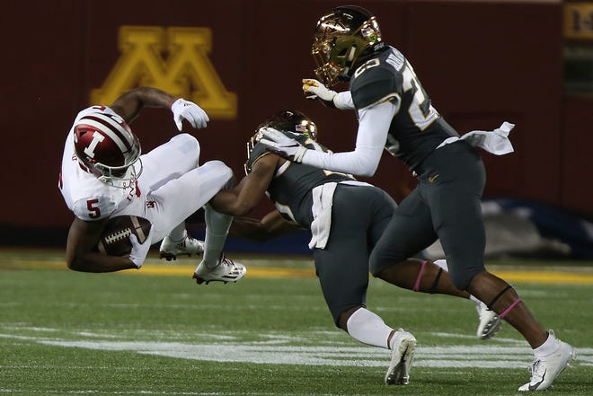Indiana wide receiver J-Shun Harris II is tackled by Minnesota's defensive back Coney Durr during an NCAA college football game Friday, Oct. 26, 2018, in Minneapolis. (AP Photo/Stacy Bengs)