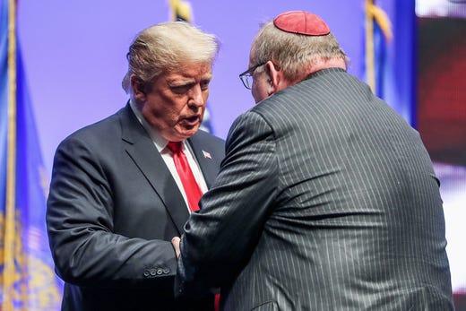 United States President Donald Trump thanks Rabbi Benjamin Sendrow after he invited Sendrow and a local pastor to say prayers in light of the morning's synagogue shooting in Pittsburgh, during his speech at the annual Future Farmers of America Convention and Expo at Banker's Life Fieldhouse in Indianapolis, Saturday, Oct. 27, 2018.