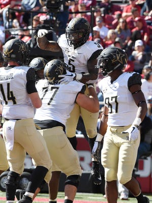 Vanderbilt running back Ke'Shawn Vaughn (5) celebrates with his team after scoring a touchdown in the second half of an NCAA college football game Saturday, Oct. 27, 2018, in Fayetteville, Ark.