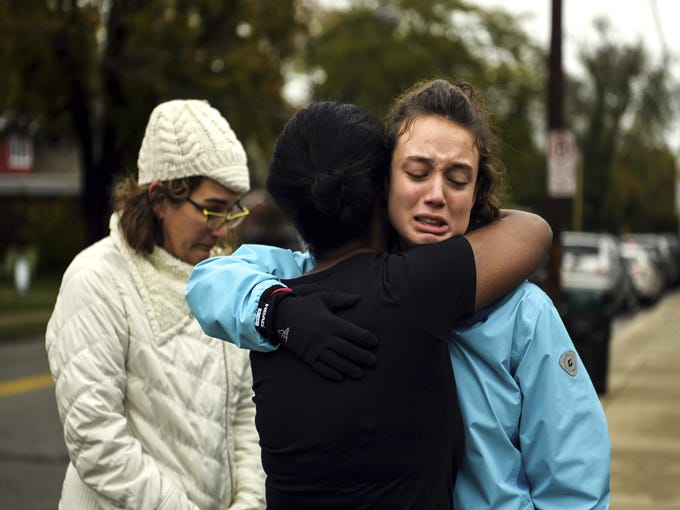 From left, Kate Rothstein looks on as Tammy Hepps hugs Simone Rothstein, 16, on the intersection of Shady Avenue and Northumberland Street after multiple people were shot at The Tree of Life Congregation synagogue, Oct, 27, 2018, in Squirrel Hill. Simone, of Squirrel Hill, is the daughter of Kate. (Alexandra Wimley/Pittsburgh Post-Gazette via AP)/Pittsburgh Post-Gazette via AP)