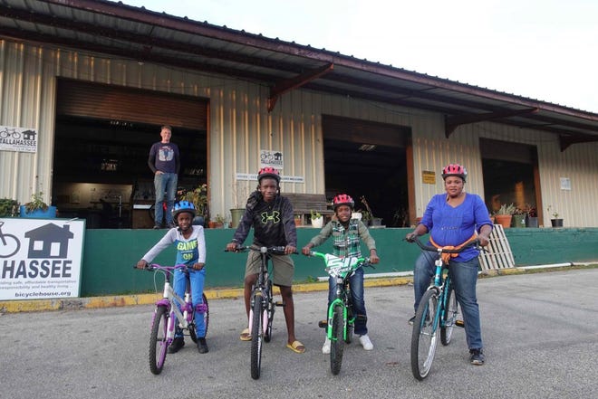 Bicycle House founder Scot Benton smiles as a family embarks on a new adventure.