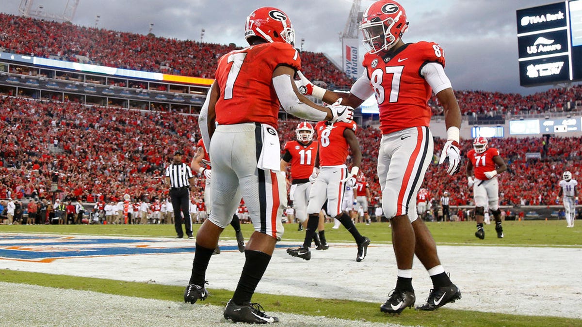Georgia running back D'Andre Swift (7) is congratulated by wide receiver Tyler Simmons after scoring a touchdown against Florida.