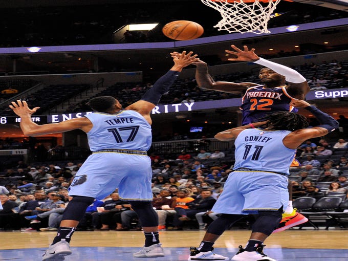Oct 27, 2018; Memphis, TN, USA; Phoenix Suns center Deandre Ayton (22) passes against Memphis Grizzlies guard Garrett Temple (17) and Memphis Grizzlies guard Mike Conley (11) during the first half at FedExForum. Mandatory Credit: Justin Ford-USA TODAY Sports