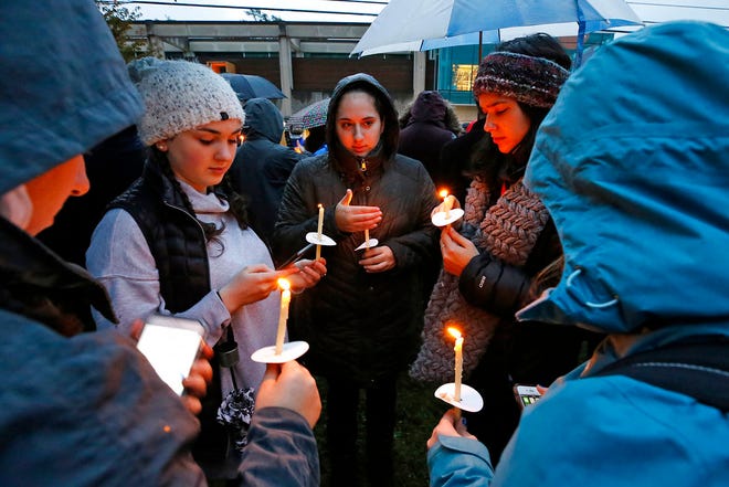 Holding candles, a group of girls wait for the start of a memorial vigil at the intersection of Murray Ave. and Forbes Ave. in the Squirrel Hill section of Pittsburgh, for the victims of the shooting at the Tree of Life Synagogue where a shooter opened fire, killing multiple people and wounding others, including sevearl police officers, Saturday, Oct. 27, 2018. (AP Photo/Gene J. Puskar)