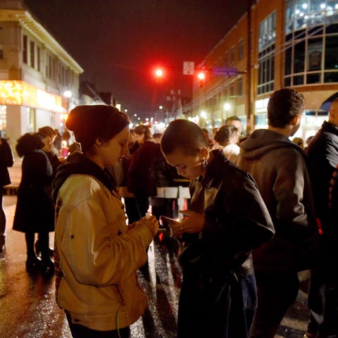 Mourners gather for a vigil in the Squirrel Hill...