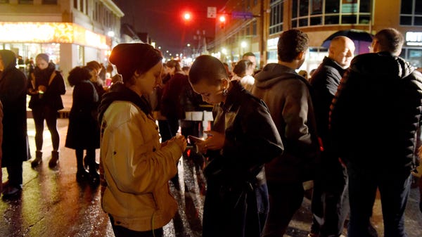 Mourners gather for a vigil in the Squirrel Hill...