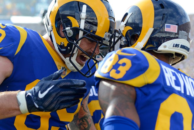 Los Angeles Rams tight end Tyler Higbee (89) congratulates wide receiver Josh Reynolds (83) after Reynolds scored a fourth quarter touchdown  against the Green Bay Packers at Los Angeles Memorial Coliseum.