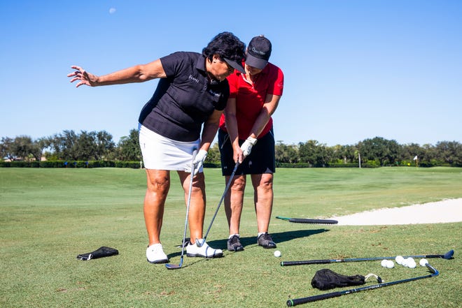 LPGA legend Nancy Lopez helps Lisa Smith during a short-game clinic before the start of the "Battle of the Sexes" two-day fundraising event for Swinging With Purpose at the Quail West Golf and Country Club in Naples on Monday, Oct. 29, 2018. 