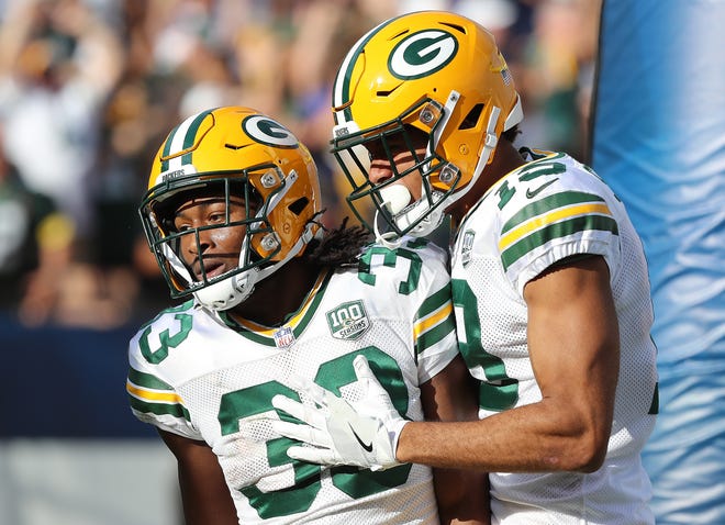 Green Bay Packers running back Aaron Jones (33) celebrates his long touchdown run with wide receiver Equanimeous St. Brown (19) against the LA Rams Sunday, October 28, 2018 at the Memorial Coliseum in Los Angeles.