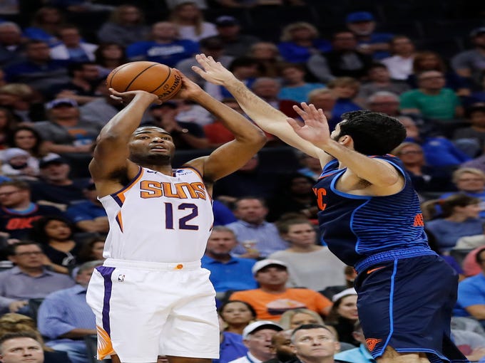 Oct 28, 2018; Oklahoma City, OK, USA; Phoenix Suns forward TJ Warren (12) shoots as Oklahoma City Thunder guard Alex Abrines (right) defended during the second quarter at Chesapeake Energy Arena. Mandatory Credit: Alonzo Adams-USA TODAY Sports