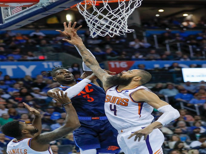 Oct 28, 2018; Oklahoma City, OK, USA; Oklahoma City Thunder forward Nerlens Noel (3) shoots as Phoenix Suns center Tyson Chandler (4) defends and guard Troy Daniels (30) looks on during the second half at Chesapeake Energy Arena. Oklahoma City won 117-110. Mandatory Credit: Alonzo Adams-USA TODAY Sports
